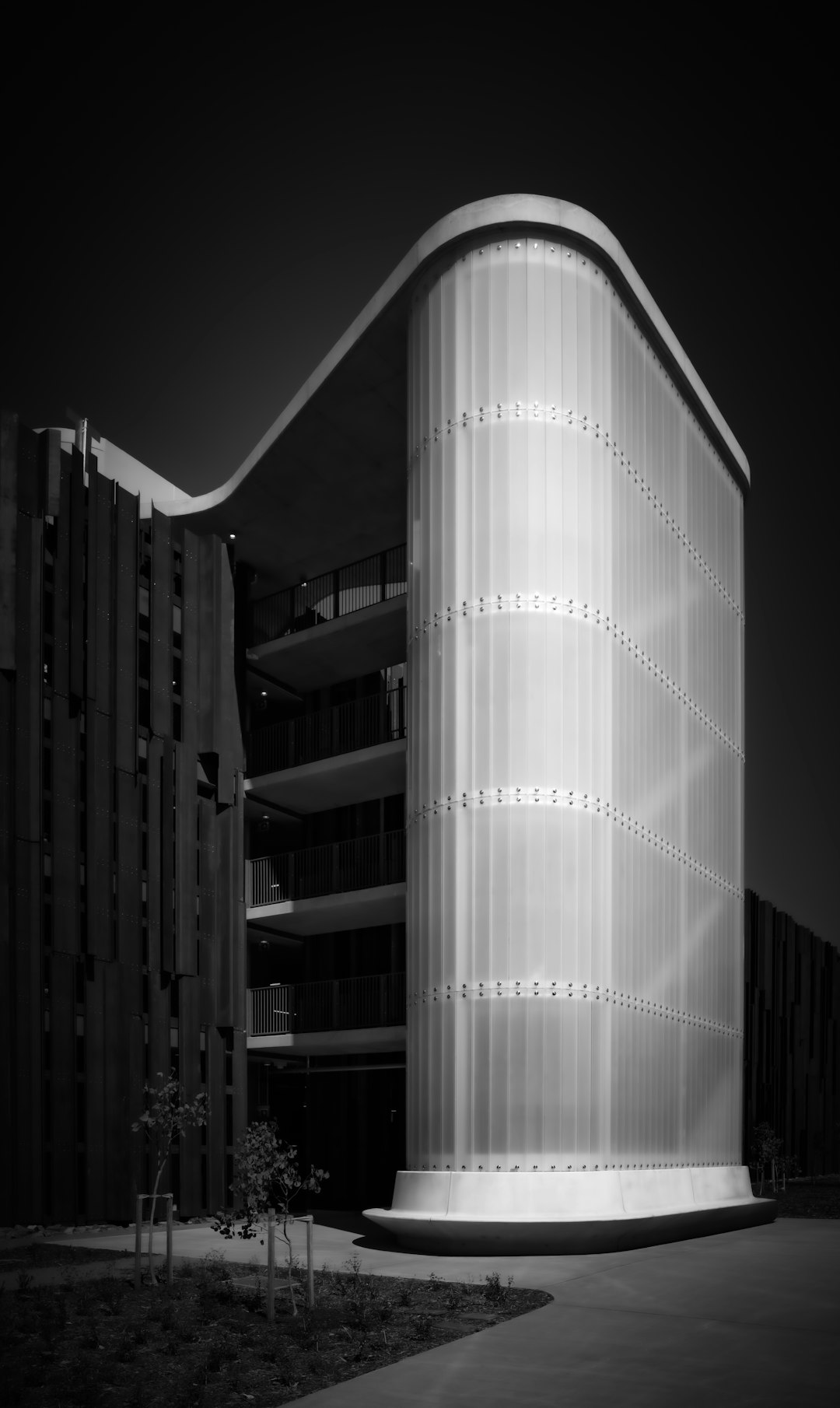modern-building-with-curved-translucent-facade-and-dark-exterior-wus-mql4zhi